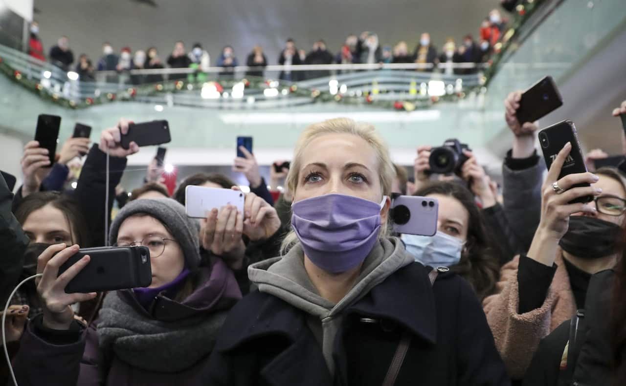 Opposition activist Alexei Navalny's wife Yulia (C) is seen at the Sheremetyevo International Airport after arriving with her husband from Berlin. 