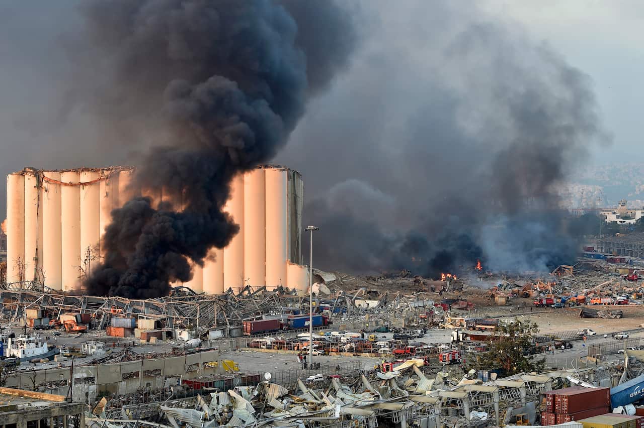 Smoke billows from harbor area with damage and debris after a large explosion rocked the harbor of Beirut, Lebanon, 4 August 2020. 