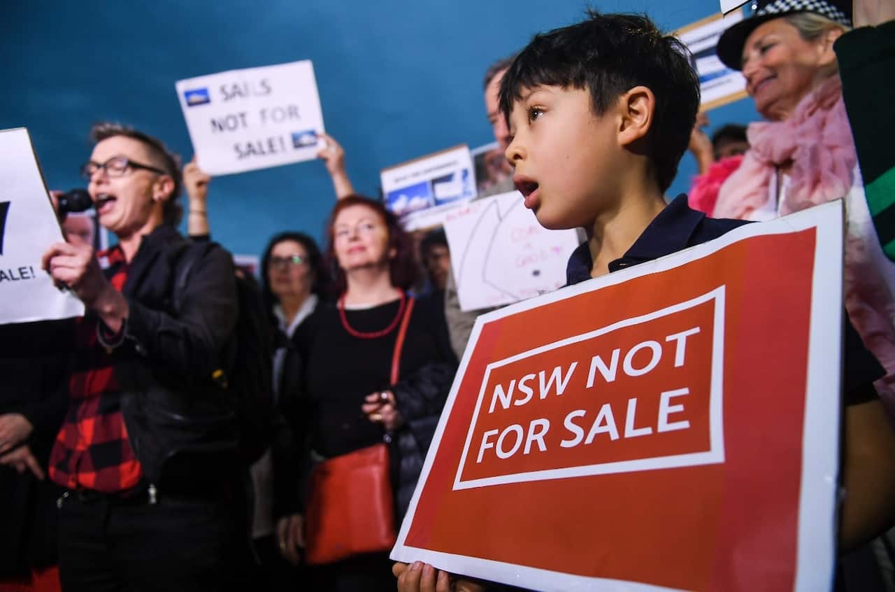 A child holds a placard during a protest against the decision to project the barrier draw results