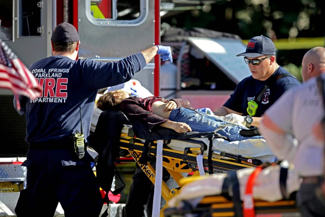 Medical personnel tend to a victim following a shooting at Marjory Stoneman Douglas High School in Parkland.