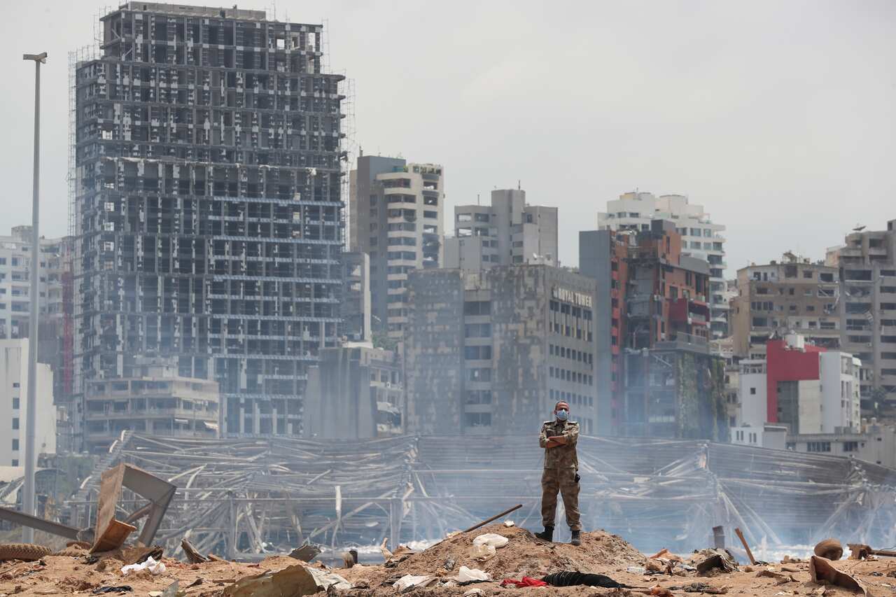 A soldier stands at the devastated site of the explosion in the port of Beirut
