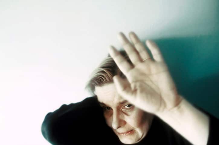 Battered woman raising her hand in self-defense