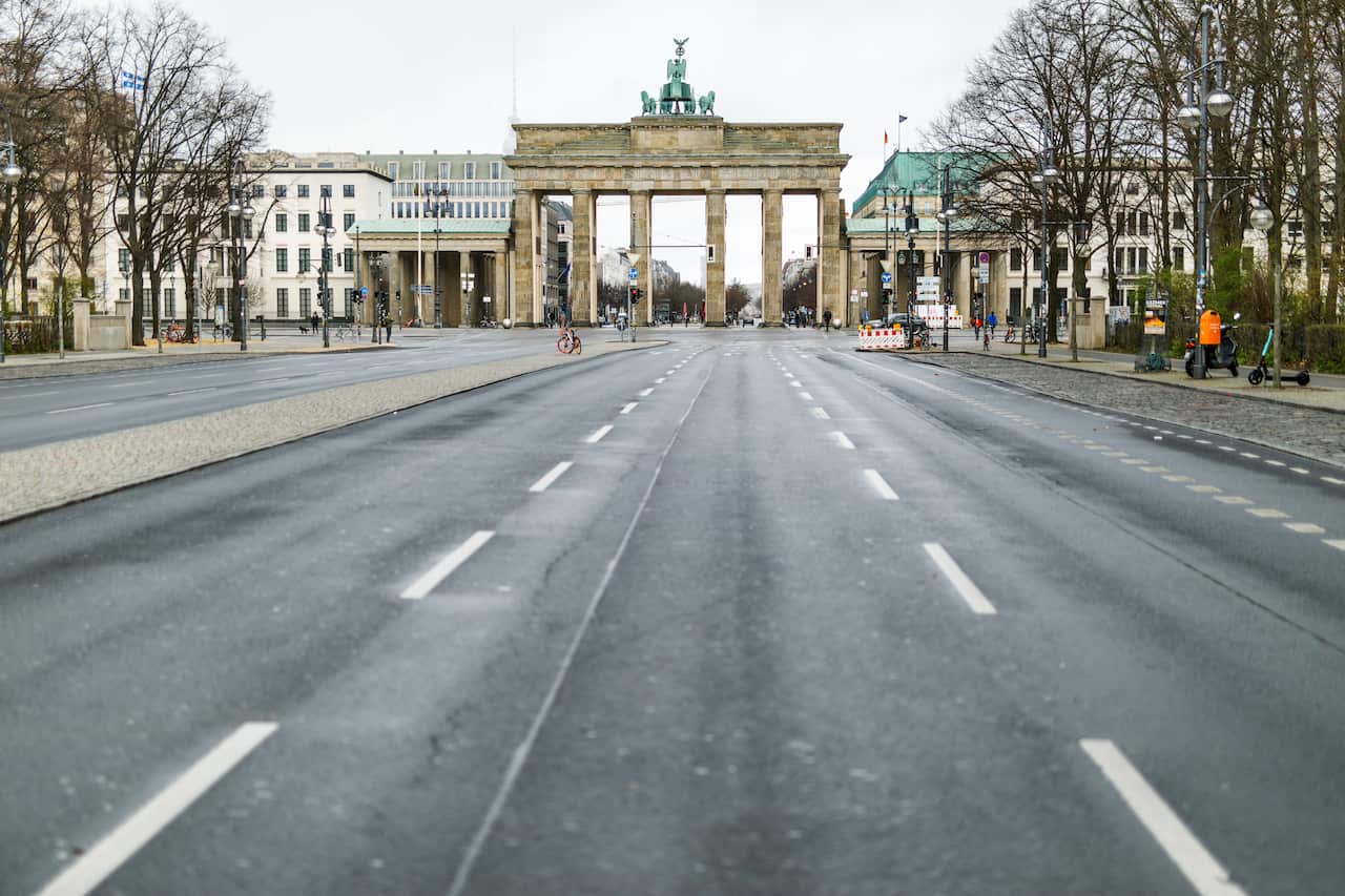 29 March 2020, Berlin: The 17 june street leading to the Brandenburg Gate is seen deserted amid restrictions on public life in light of the coronavirus outbreak. Photo: Carsten Koall/dpa