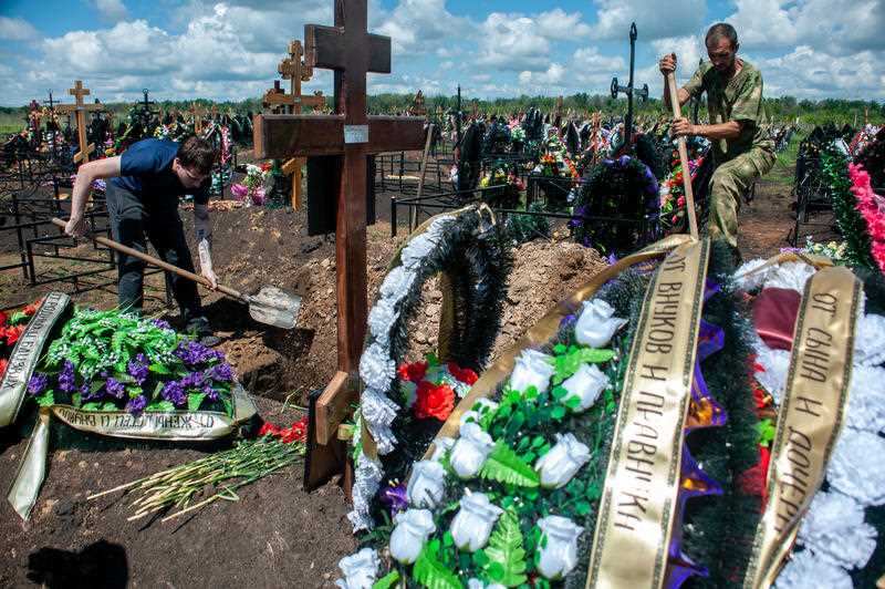 Gravediggers are seen working on a grave at the Polynkovsky cemetery in Russia, which has the world's second highest mortality rate from COVID-19.