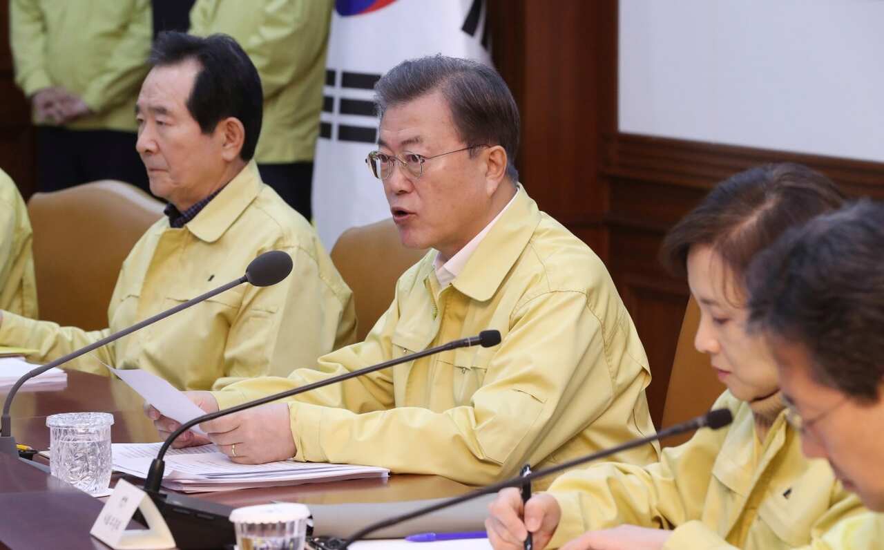 South Korean President Moon Jae-in, center, speaks during a meeting at a government complex in downtown Seoul, South Korea, Sunday, Feb. 23, 2020. 