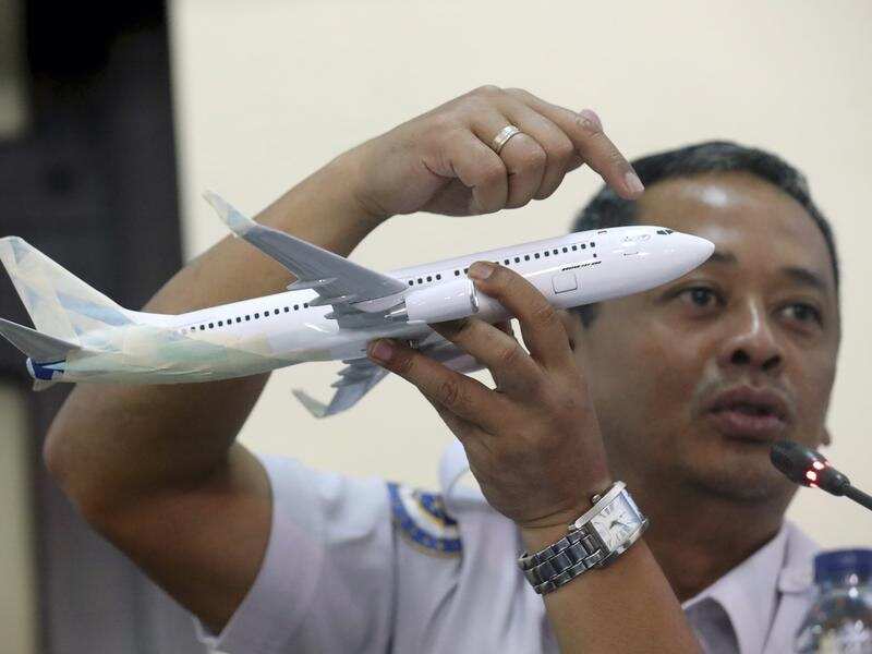 Indonesian air safety investigator with a model plane