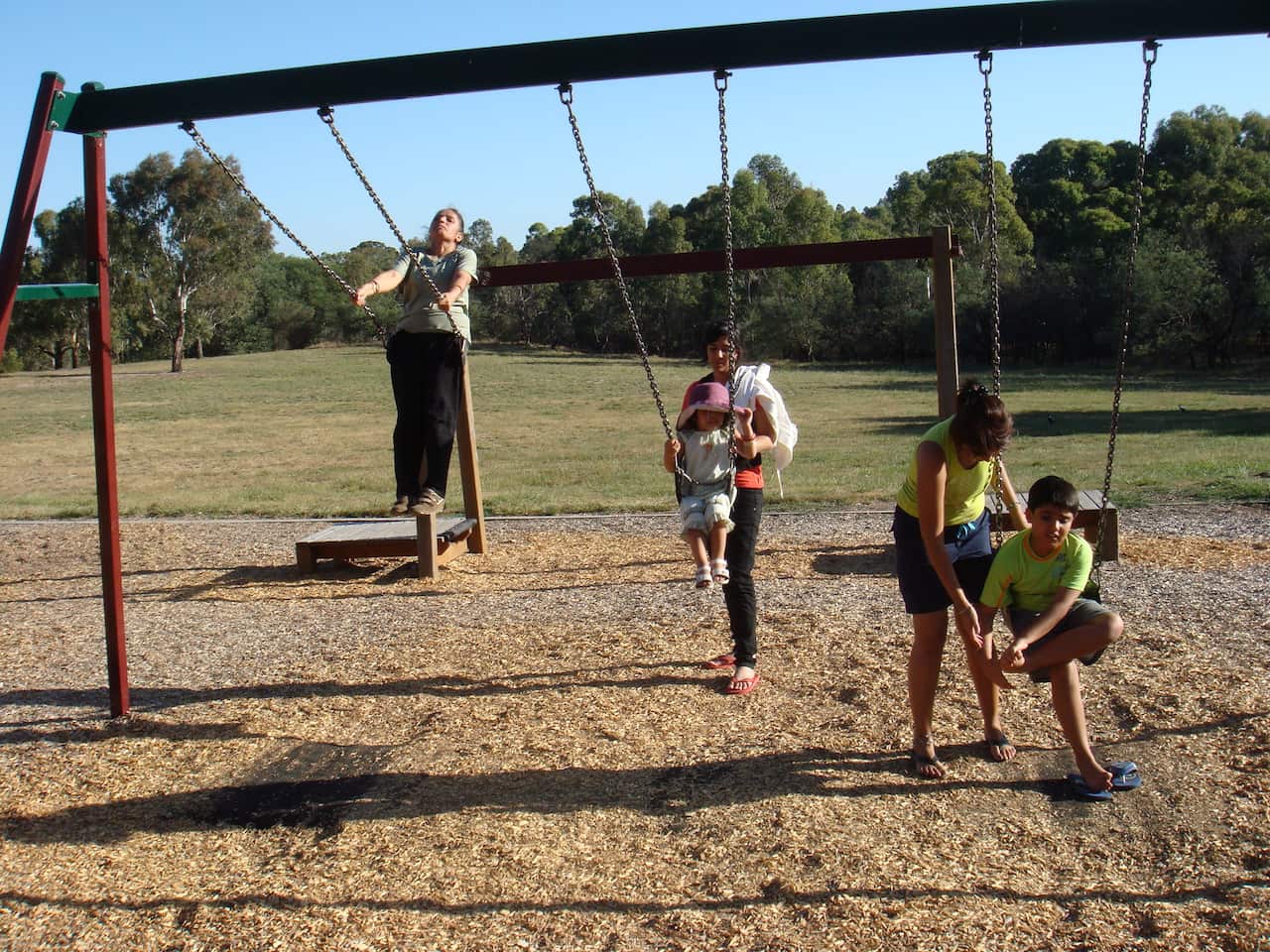 Bhajan Kaur (L) in a park swing