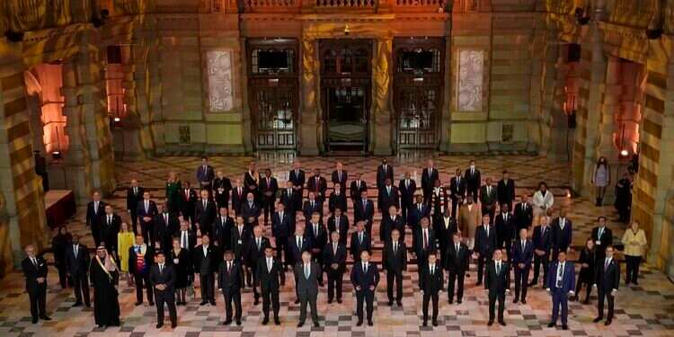 World leaders pose for a group photo during an evening reception to mark the opening day.