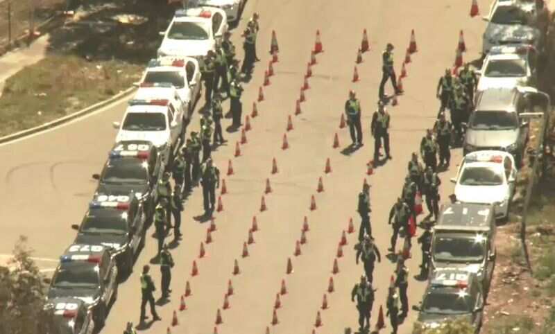 Authorities have set up an elaborate checkpoint with roads blocked off and hundreds of witches hats lining the road in Sunshine West
