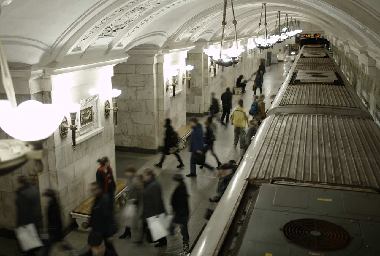 Blurred people on subway platform.