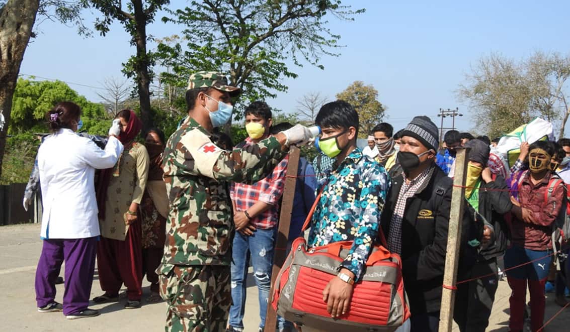 Body temperature check of visitors by Nepali officials.