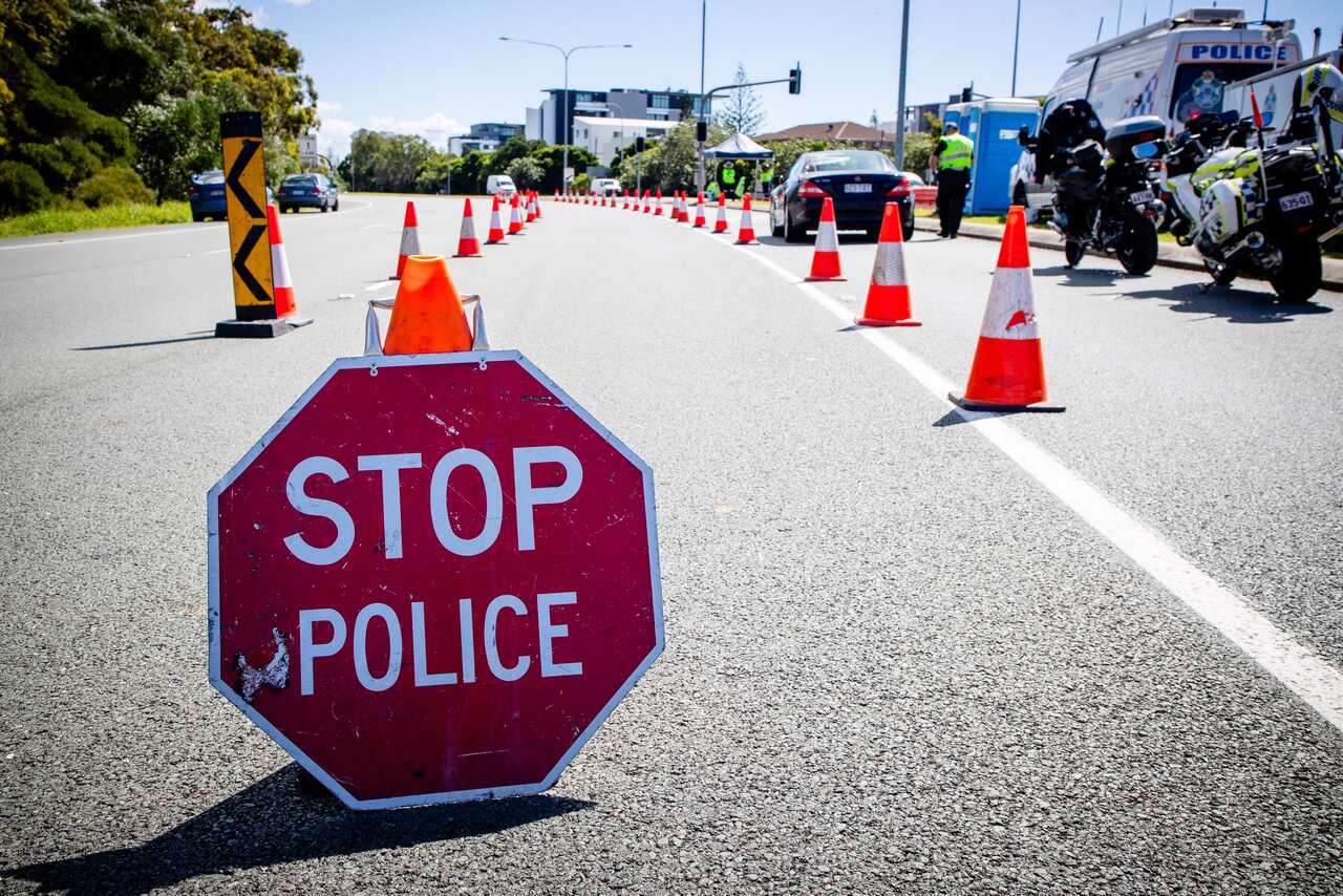 A vehicle stops at a checkpoint on the Pacific Highway on the Queensland - New South Wales border 