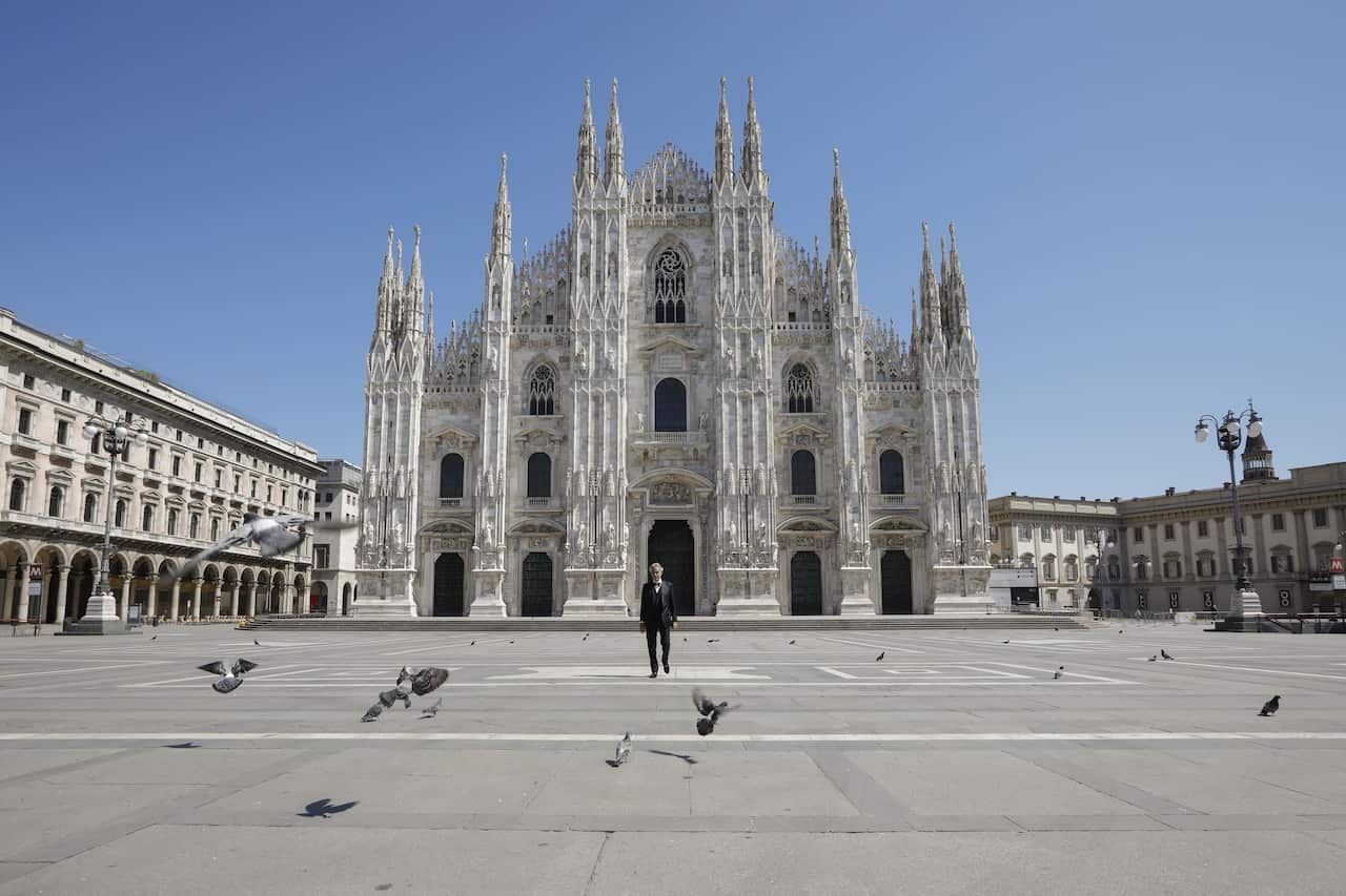 Tenor Andrea Bocelli walking in Piazza Duomo, Milan