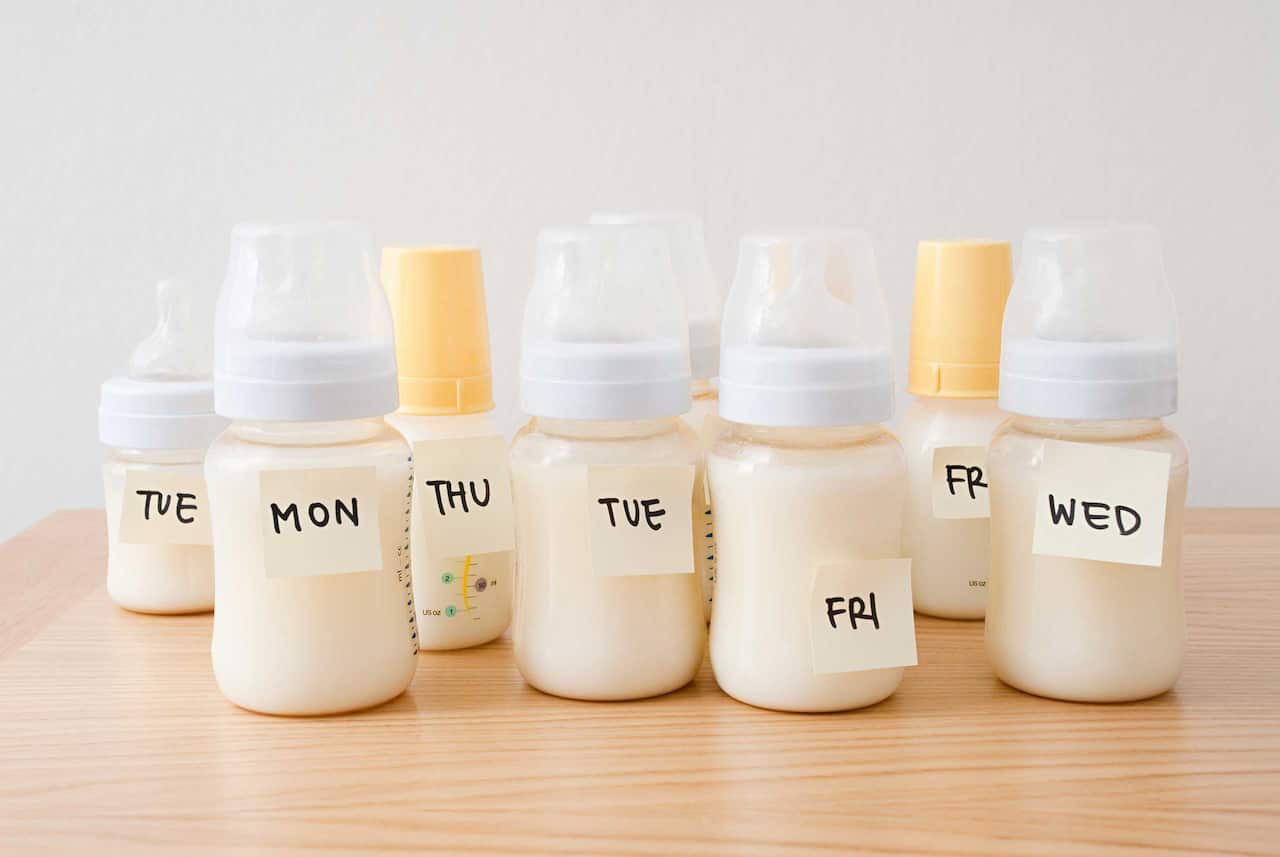 Baby bottles with days of the week on adhesive notes