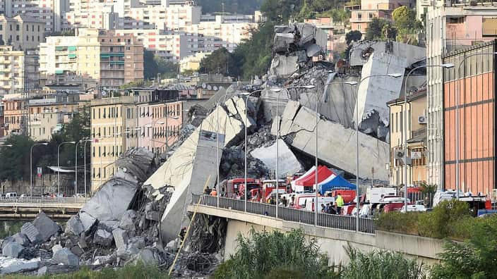 Rescuers work to recover an injured person after the Morandi highway bridge collapsed in Genoa, northern Italy, Tuesday, Aug. 14, 2018. 