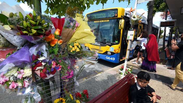 A floral tribute is seen at a bus stop in Morooka, Brisbane, Sunday, Oct. 30, 2016. Bus driver Manmeet Sharma, also known Manmeet Alisher, died after he was set alight by 48-year-old