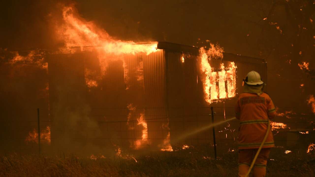 NSW Rural Fire Service crews fight the Gospers Mountain Fire as it impacts a property at Bilpin, Saturday, December 21, 2019. Conditions are expected to worsen across much of NSW as temperatures tip 40C. (AAP Image/Dan Himbrechts) NO ARCHIVING