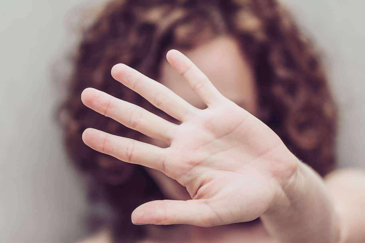 Woman makes stop gestures