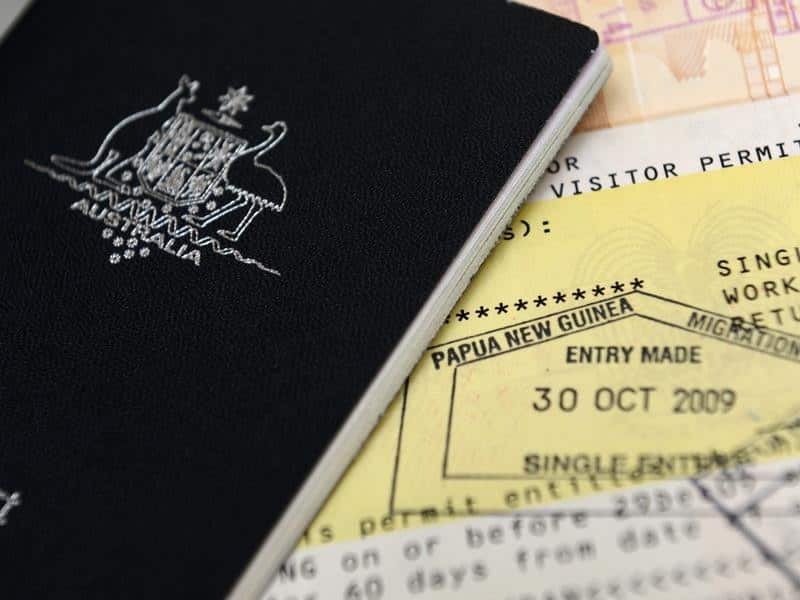 File image of an Australian passport pictured next to an entry visa