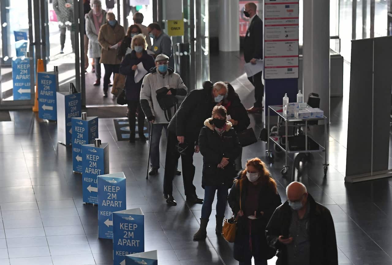 People queuing to receive an injection of a COVID-19 vaccine at the NHS vaccine centre in Birmingham, UK, 11 January 2021.
