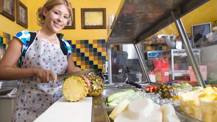 Portrait of young woman working in diner