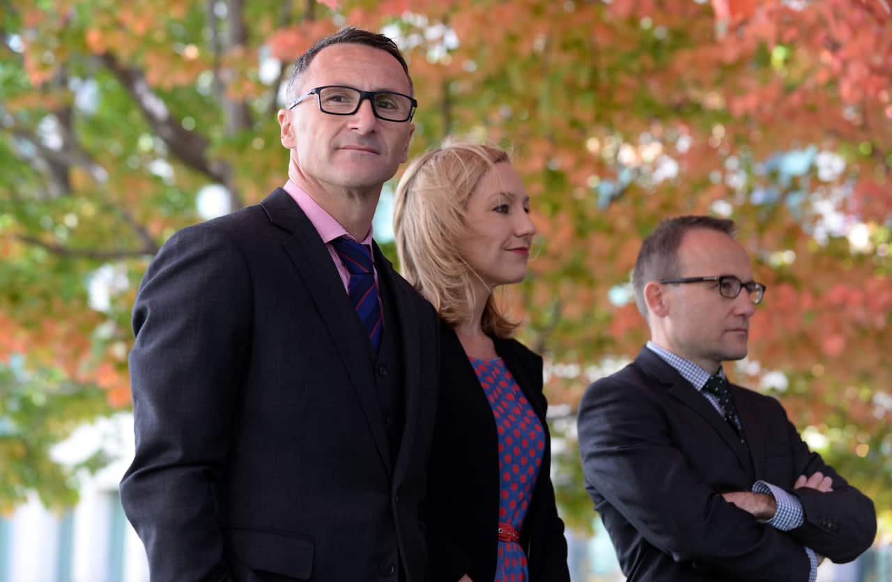 Outgoing Greens Leader Richard Di Natale stands alongside Senators Larissa Waters and Adam Bandt.