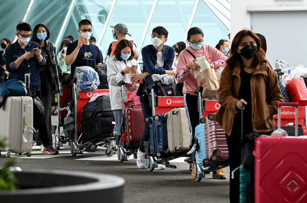 International students wear face masks as they arrive at Sydney Airport in Sydney, Monday, 6 December, 2021.