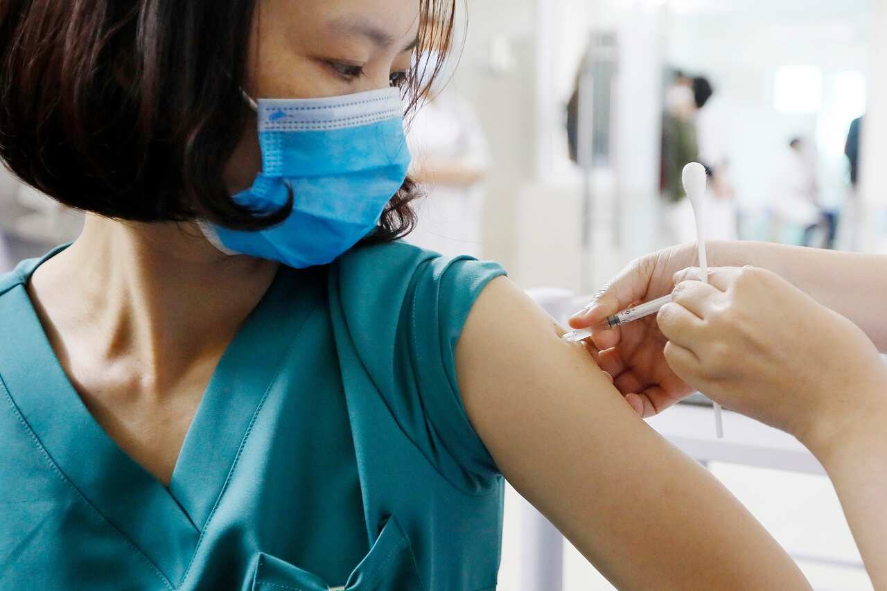 A medical worker receives a COVID-19 vaccine dose at the Thanh Nhan hospital in Hanoi, Vietnam.
