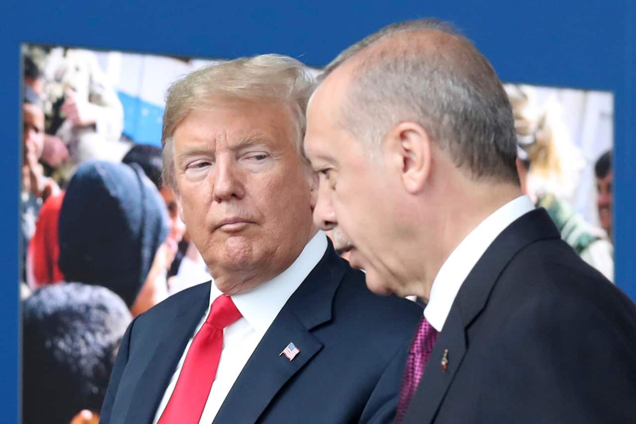President Donald Trump, left, talks to Turkish US President Recep Tayyip Erdogan as they tour the new NATO headquarters in Brussels, Belgium, July 11, 2018