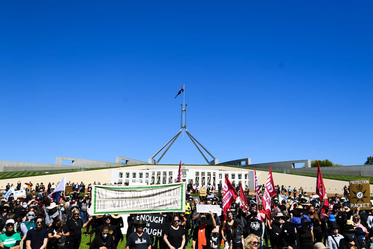Protesters attend the Women's March 4 Justice in front of Parliament House in Canberra on Monday.