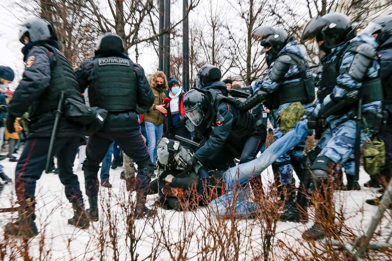 Riot police detain a demonstrator with a bloody face during a protest against the jailing of Alexei Navalny in Pushkin square in Moscow, Russia.