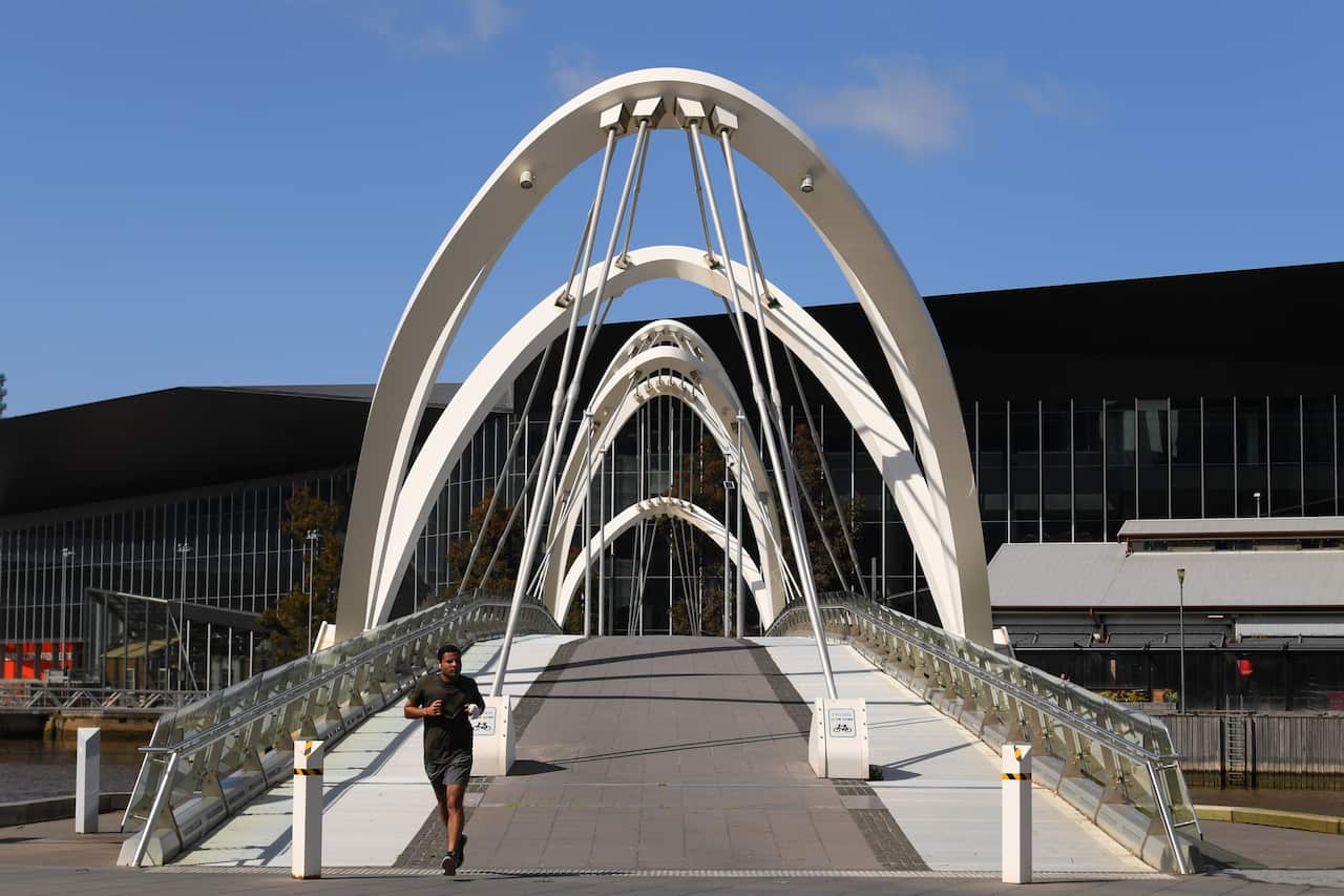 A person is seen exercising in Melbourne, Thursday, October 1, 2020. Victoria has recorded 15 new cases of coronavirus and two deaths in the past 24 hours (AAP Image/James Ross) NO ARCHIVING