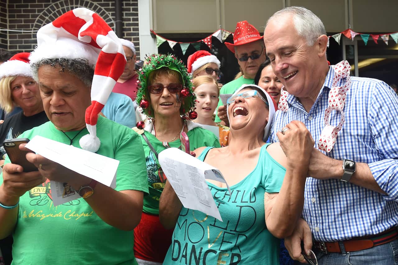 Then-prime minister Malcolm Turnbull joins singers at the Wayside Chapel Christmas Day street party in Sydney in 2015. The event won't go ahead this year.