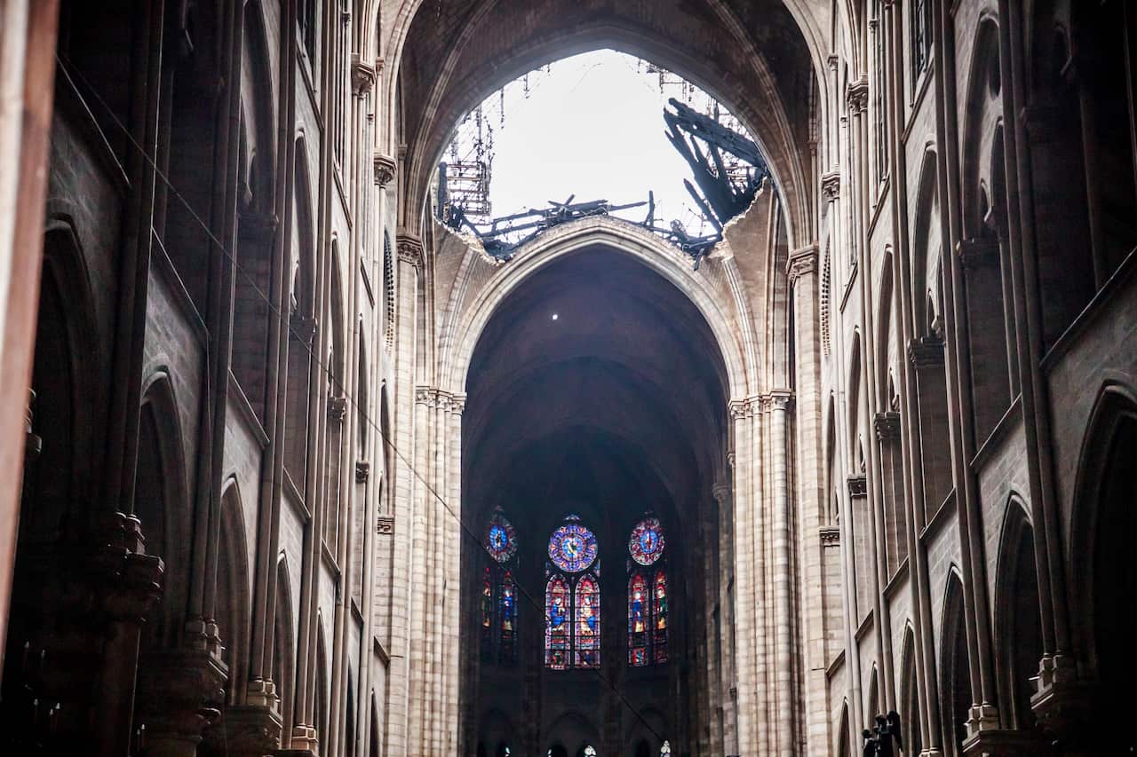 A hole is seen in the dome inside the damaged Notre Dame cathedral in Paris.