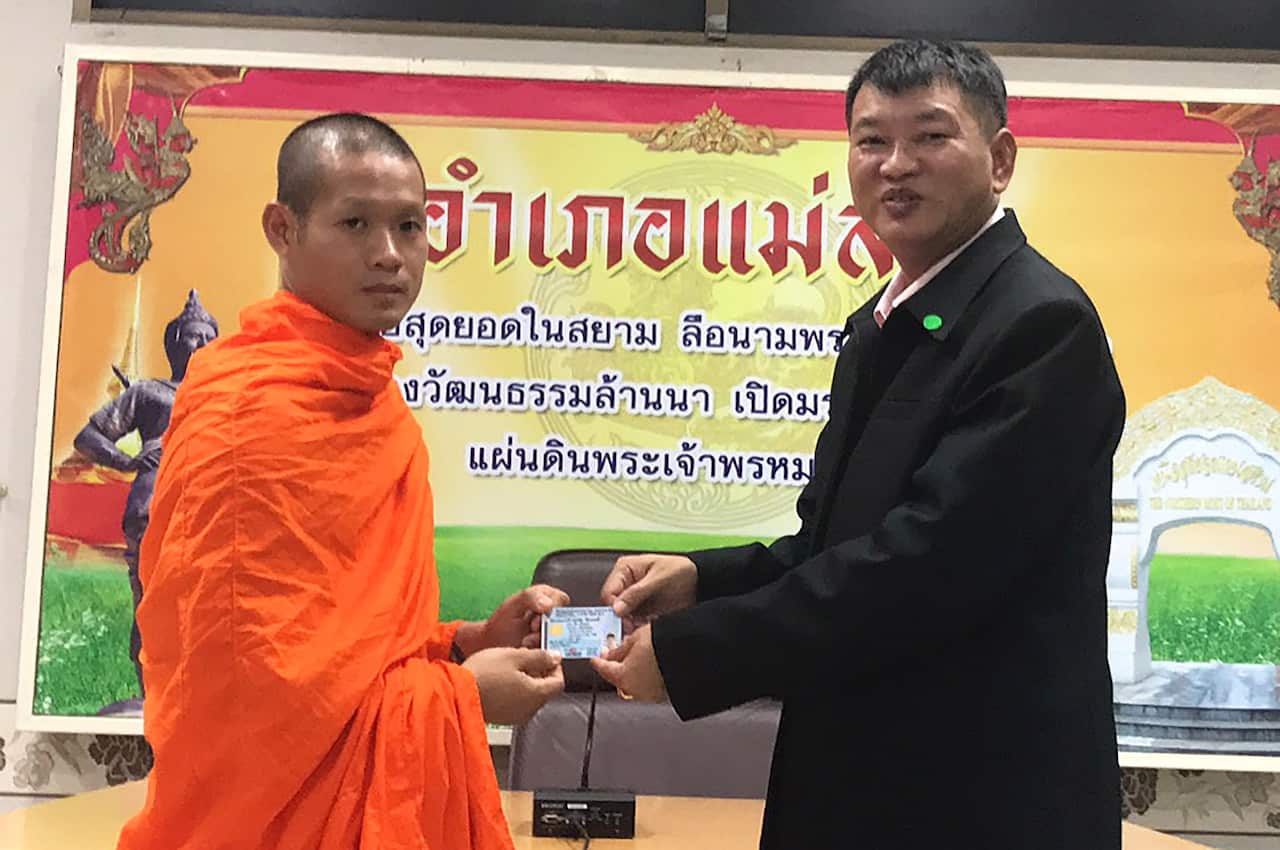 The Wild Boar soccer team coach-turned-Buddhist monk Ekapol Chantawong as he receives his Thai citizen ID card