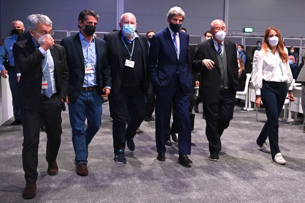 US Special Presidential Envoy for Climate John Kerry (4th L) and Chief Negotiator of China, Xie Zhenhua (5th L) leave the room at COP26 on 13 November 2021 in Glasgow, Scotland. 