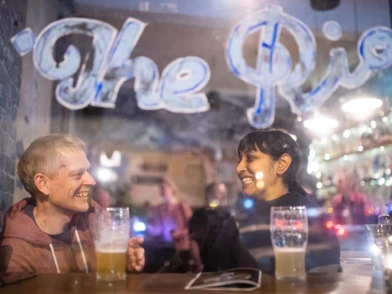 A couple enjoy drinks at a Sydney venue