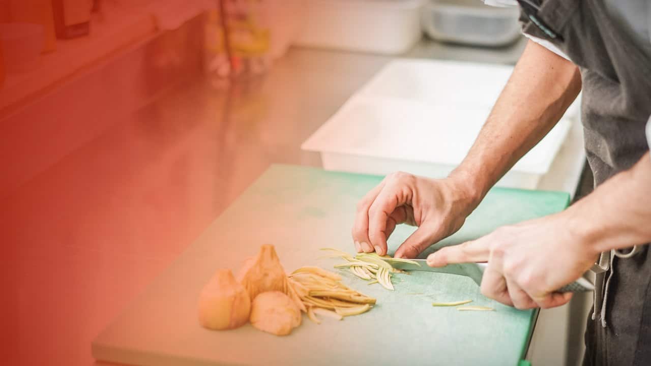 Chef chopping shallots