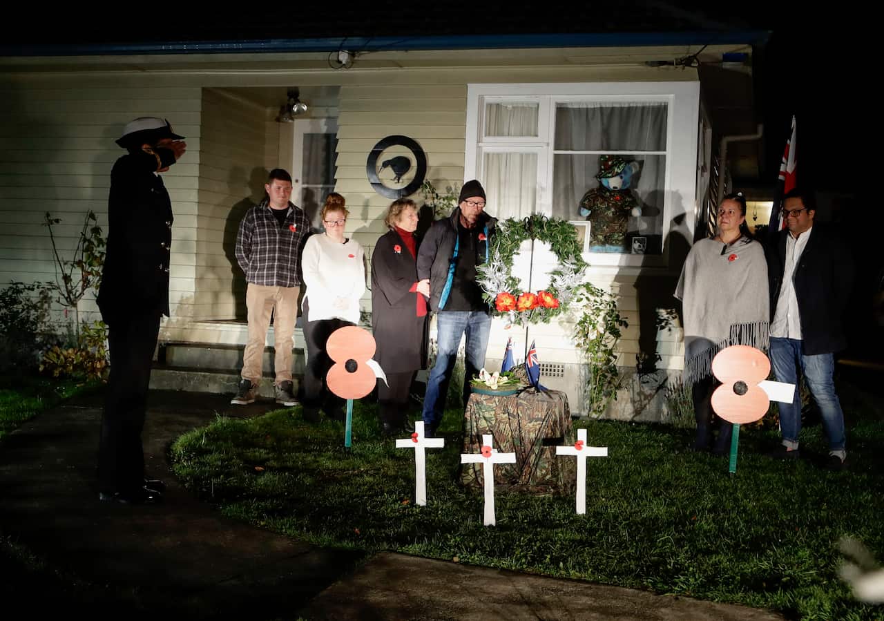 Neighbours gather at dawn to commemorate Anzac Day in a suburb of Christchurch, New Zealand.