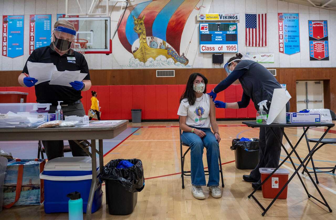 Sophia Lopez, a high school student, receives her first dose of the Pfizer vaccine at a mobile clinic in Salinas, California, on Thursday, 15 April.