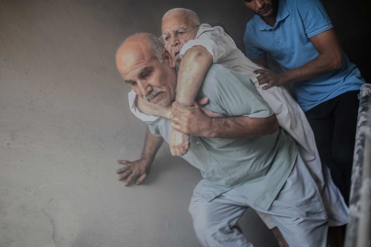 An elderly man is evacuated from a building in Akcakale, a town near the Turkish border after it was hit by a rocket reported to be fired from Syria.