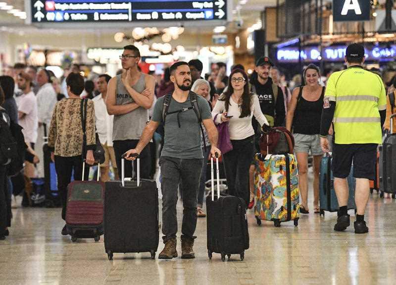 Representational image of Travellers are seen at Overseas Arrivals and Departures (OAD) at Sydney's International Airport in Sydney