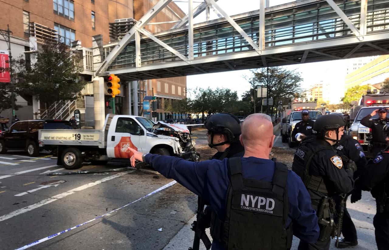 New York City Police Officers respond to report of gunfire along West Street near the pedestrian bridge at Stuyvesant High School in lower Manhattan in New York, Tuesday, Oct. 31, 2017.