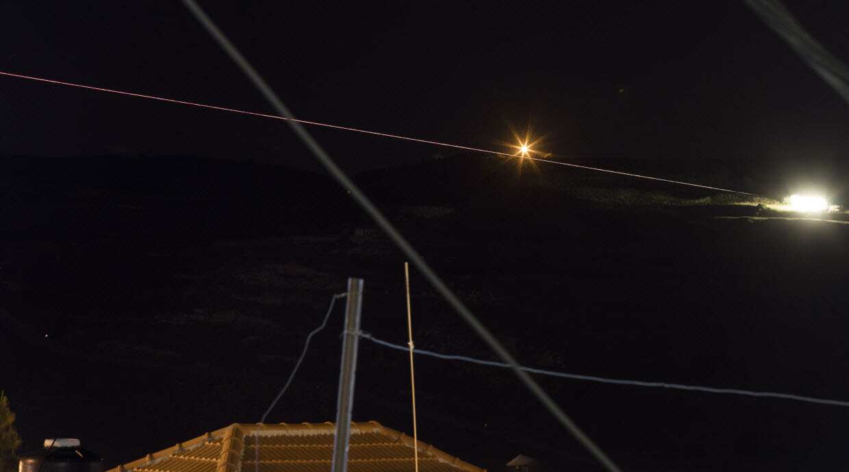 A long exposure picture shows Israeli artillery deployed missiles toward Syrian military targets, on the Golan Heights, next to the Israeli-Syrian border.