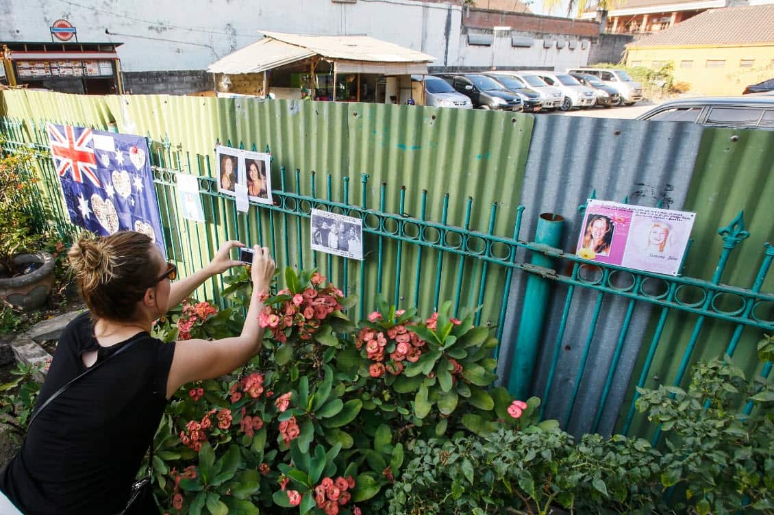 A tourist takes a picture at the former site of the Sari Club.