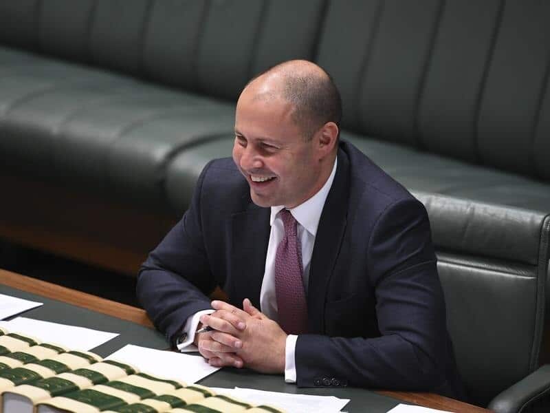 Josh Frydenberg laughs during a tax cuts debate in parliament.