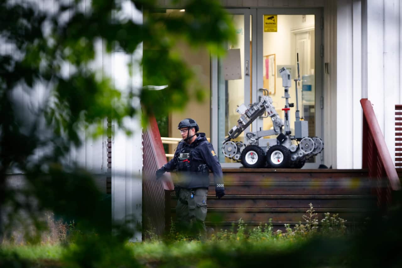 A Police officer with a robot on a site of a shooting inside the al-Noor Islamic center mosque in Baerum outside Oslo, Norway