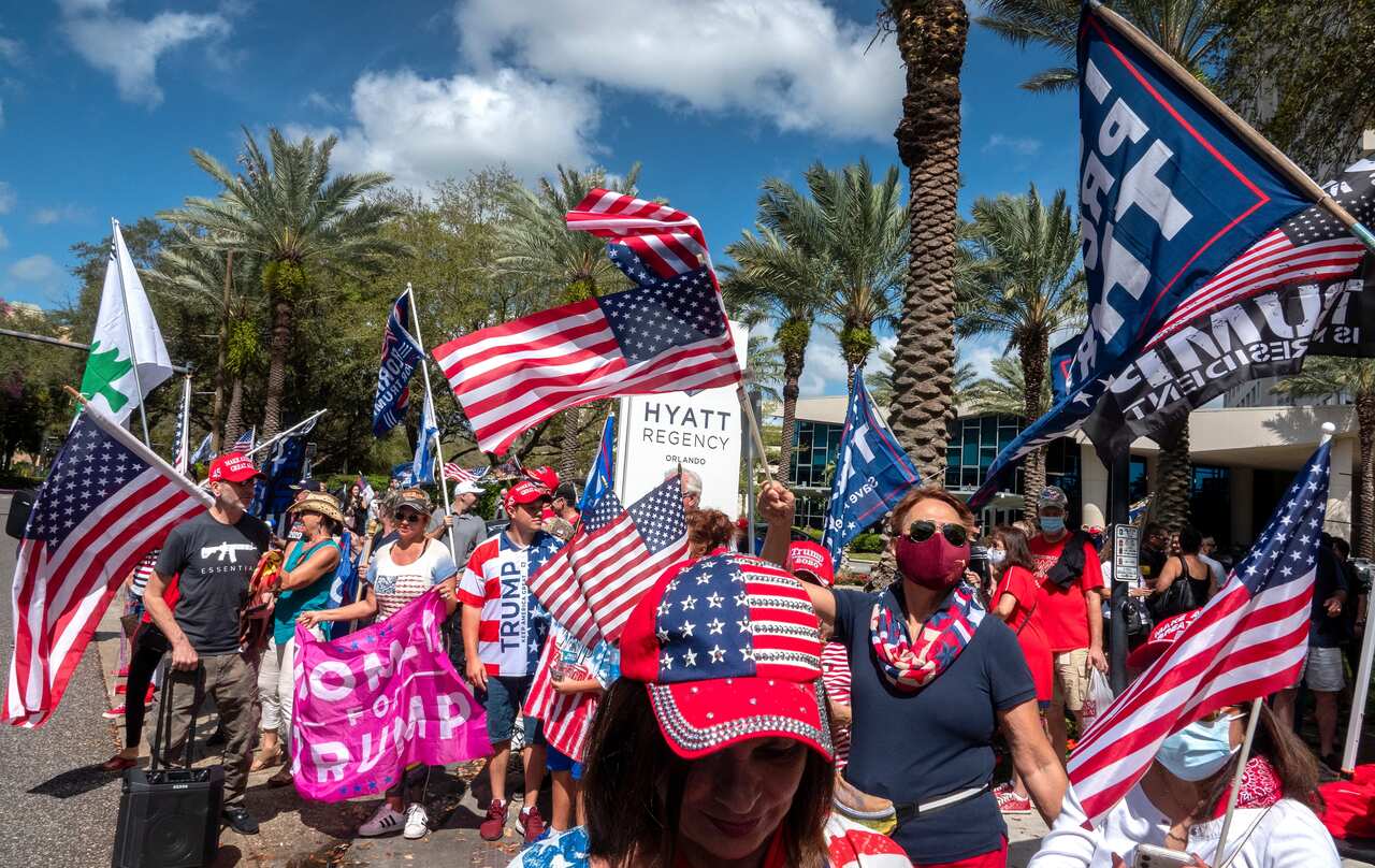 Supporters of former US president Donald Trump stand in front of the Hyatt Regency Orlando where the annual CPAC is being held.