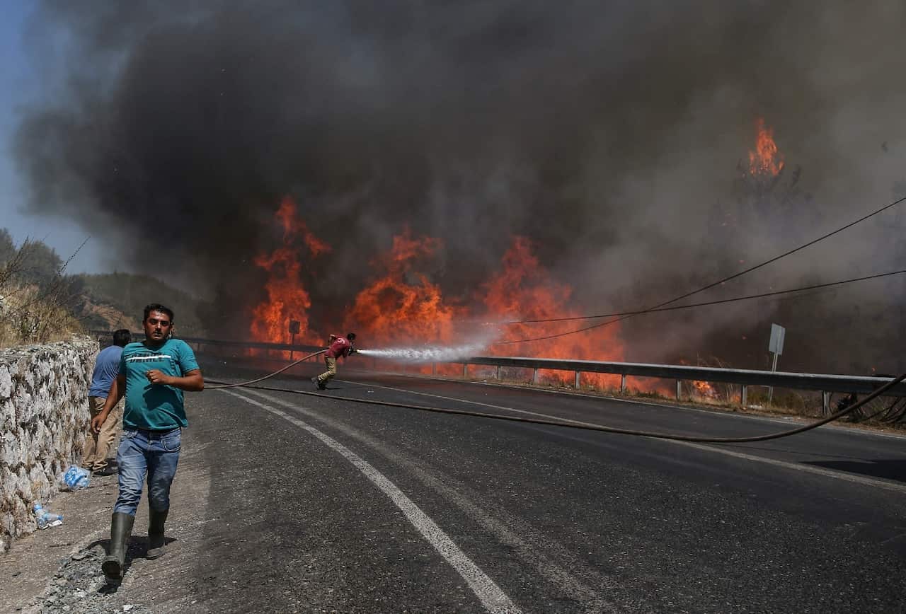 Firefighters try put out the wildfires at the rural of Marmaris district of Mugla, Turkey. 
