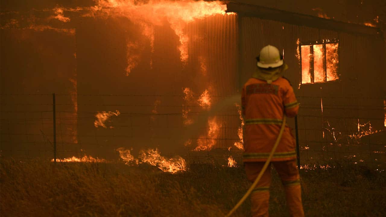 Rural Fire Service crews fight the Gospers Mountain Fire last week. Bushfire conditions will remain high over the newyear.